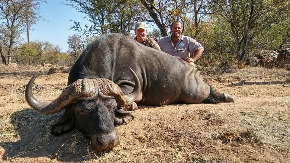 A client next to their hunting trophy
