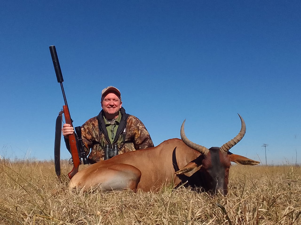 A client next to their hunting trophy