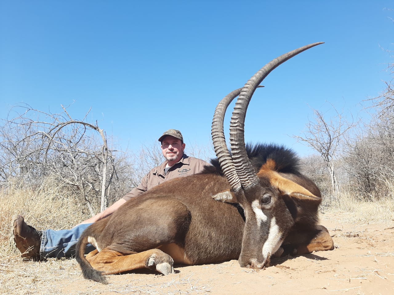 A client next to their hunting trophy