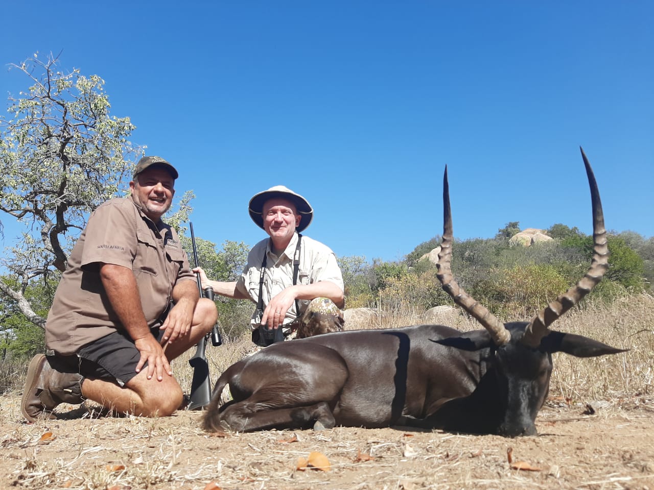 A client next to their hunting trophy