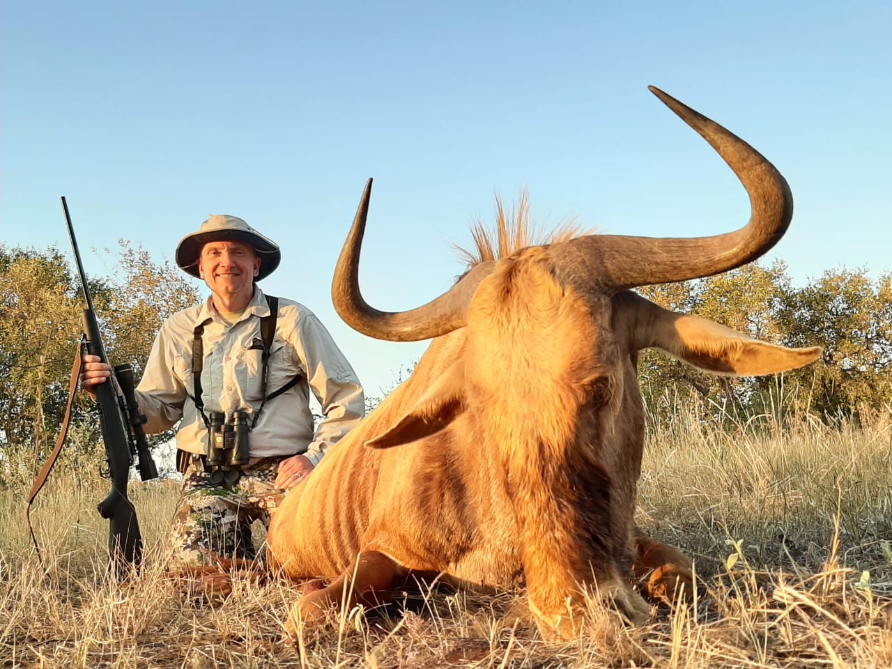 A client next to their hunting trophy