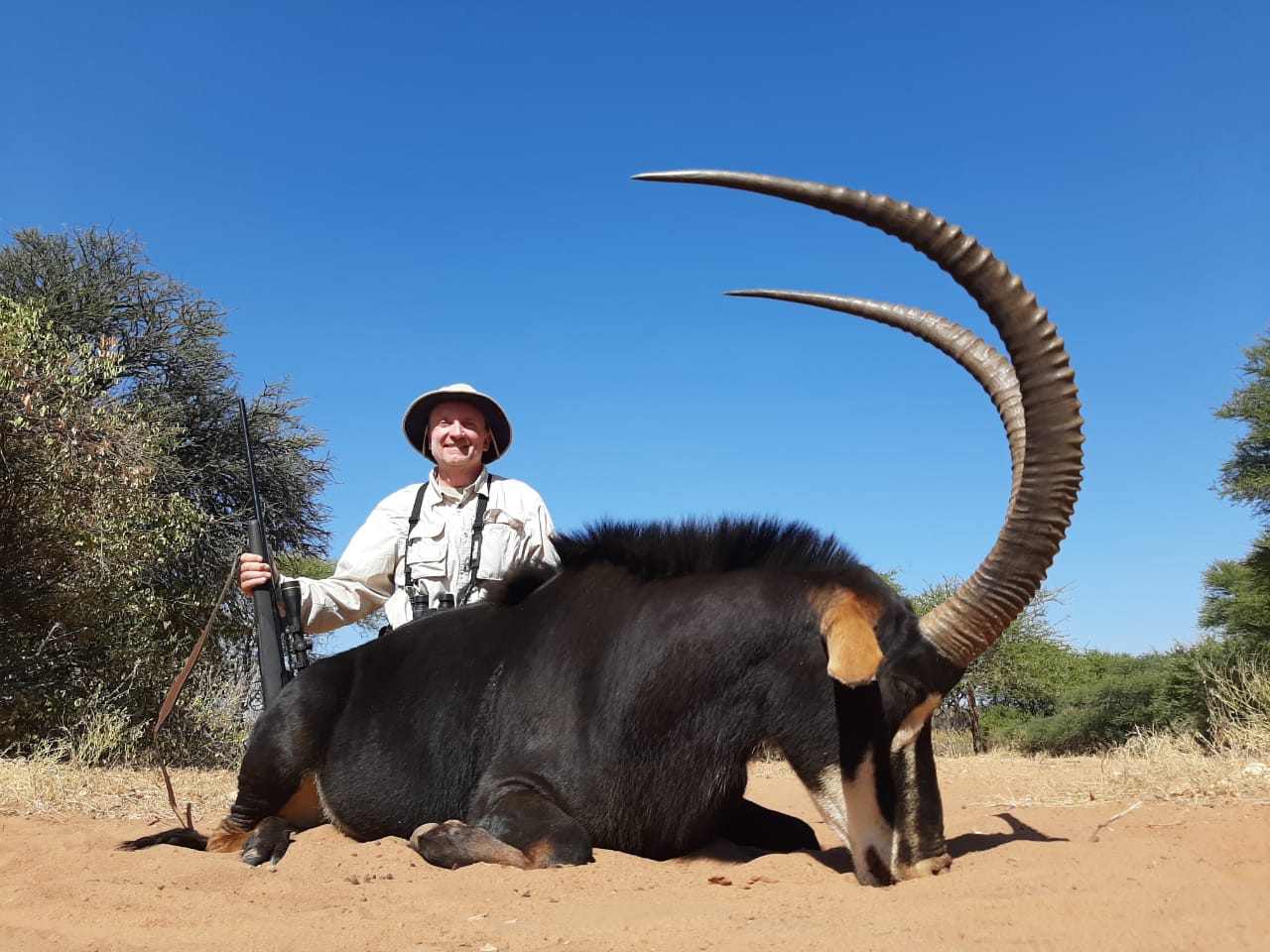 A client next to their hunting trophy