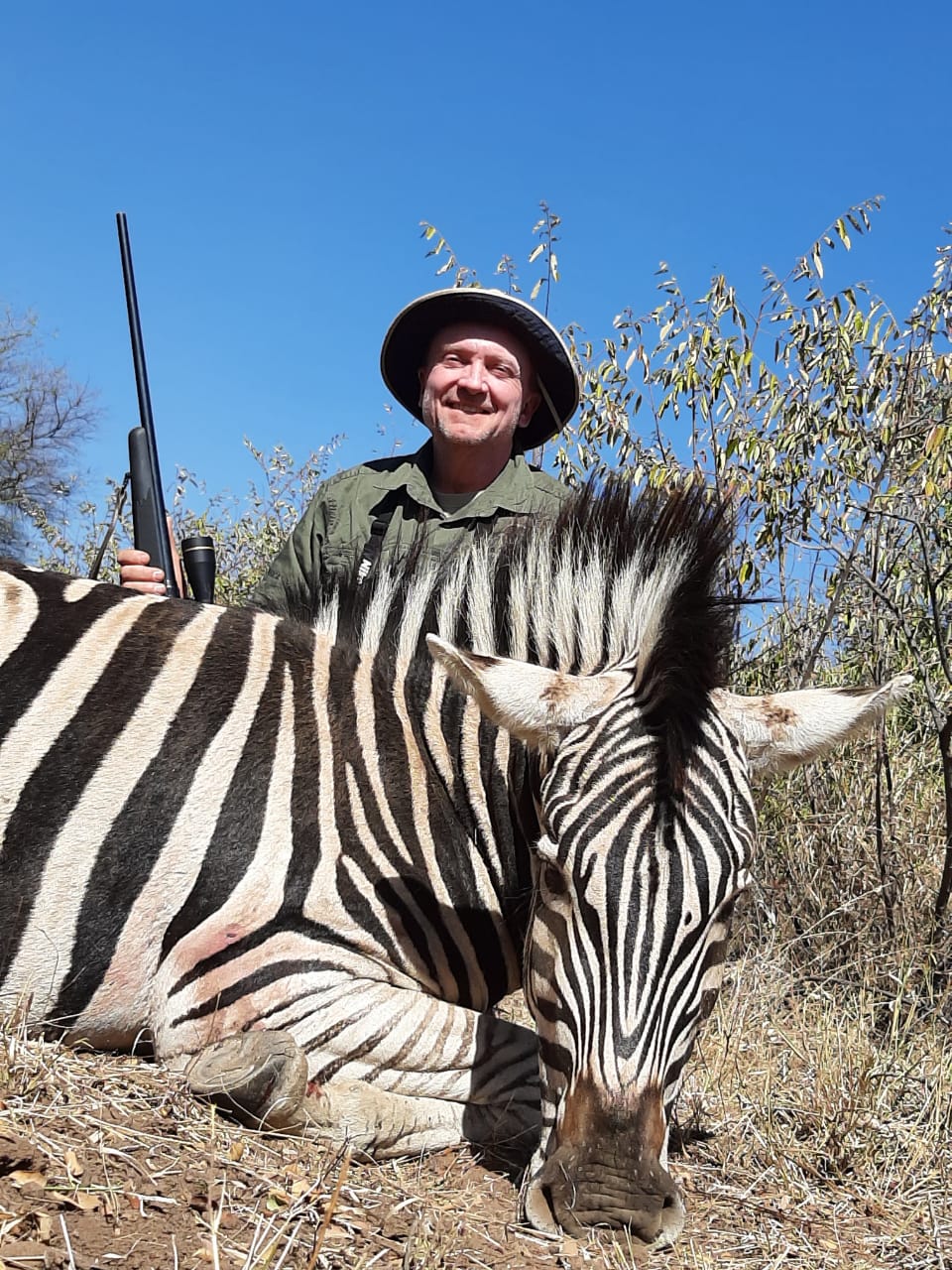 A client next to their hunting trophy