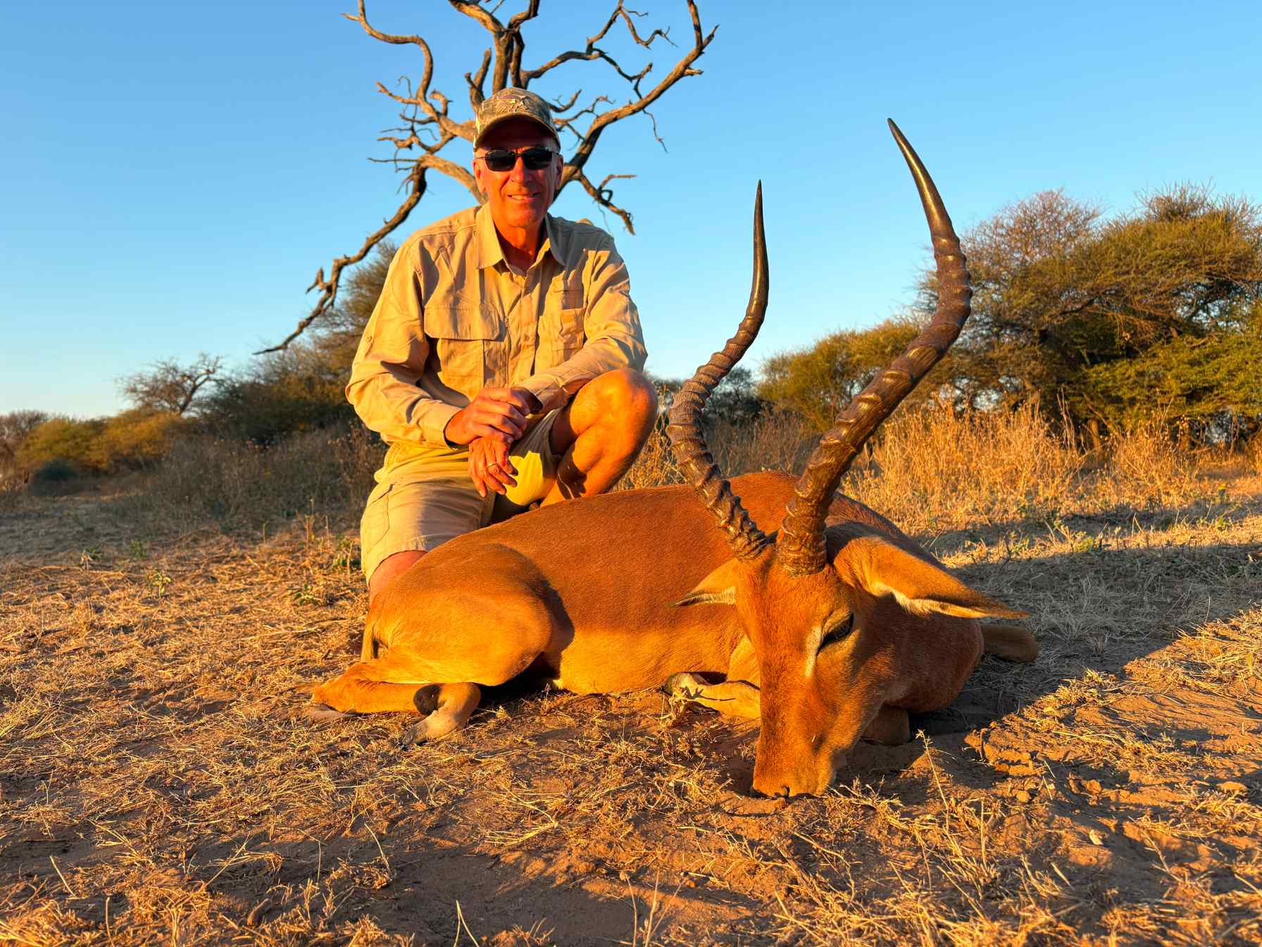 A client next to their hunting trophy