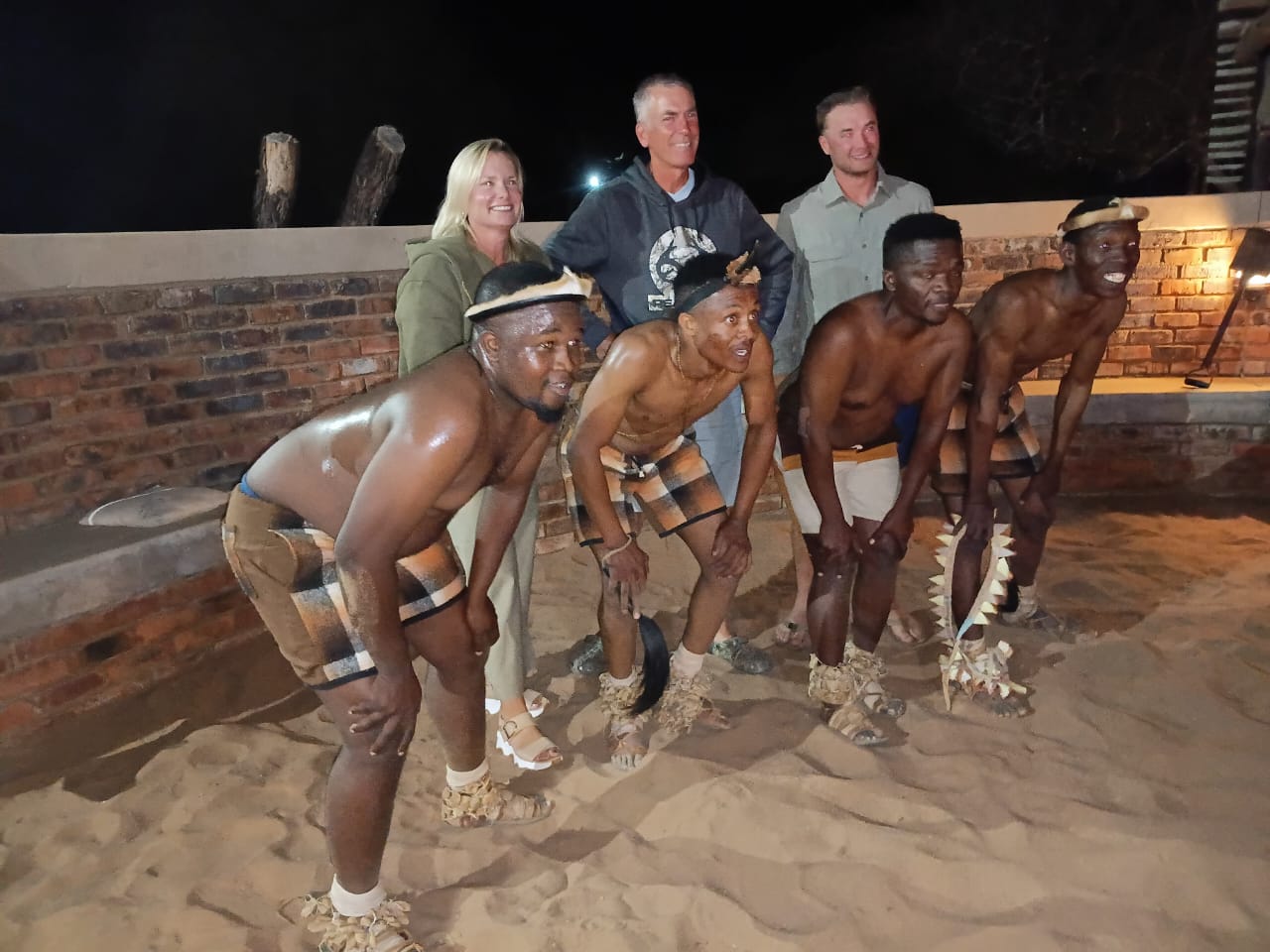 A client with a group of indigenous people smiling